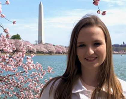 Photo of Alicia Brownlee in front of cherry blossoms